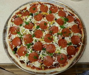 Phew!  There it is!  If you love your Pepperoni with crispy edges (heeaaven) then place them on the very top of the toppings and cheeses. Then I sprinkle a little Parsley on top. You know, it freshens your breath after you eat the onions, garlic and pepperoni...Not!! Just like the fresh herbs.